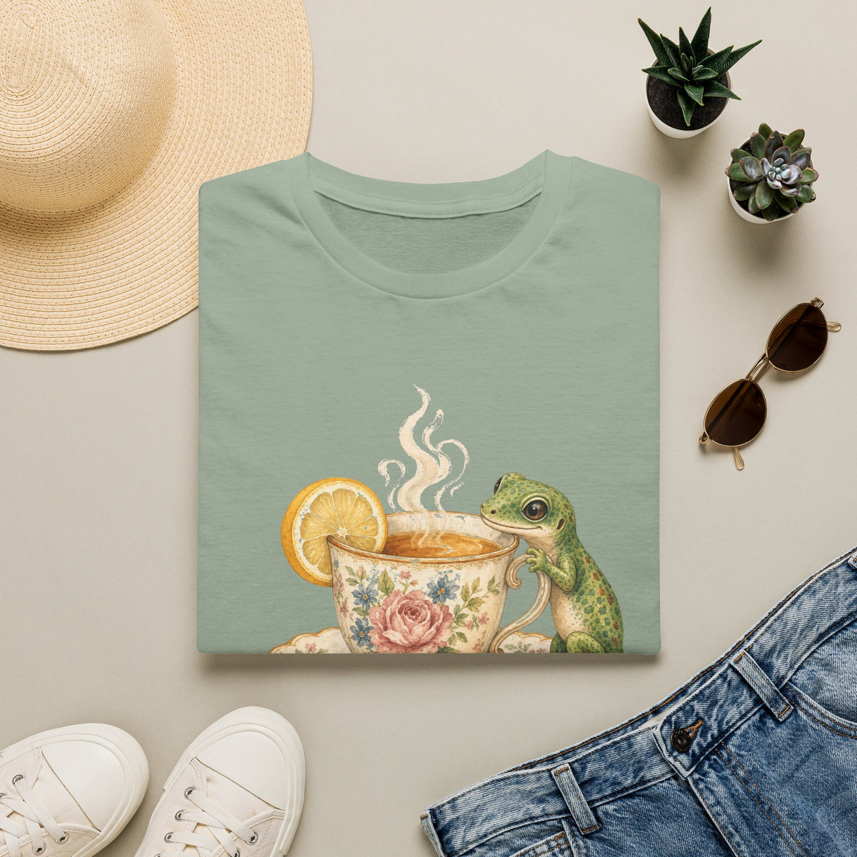Tea Time Gecko cottagecore watercolor T-shirt from Gold Gecko Co. — gecko sipping from a floral teacup among daisies and lavender.