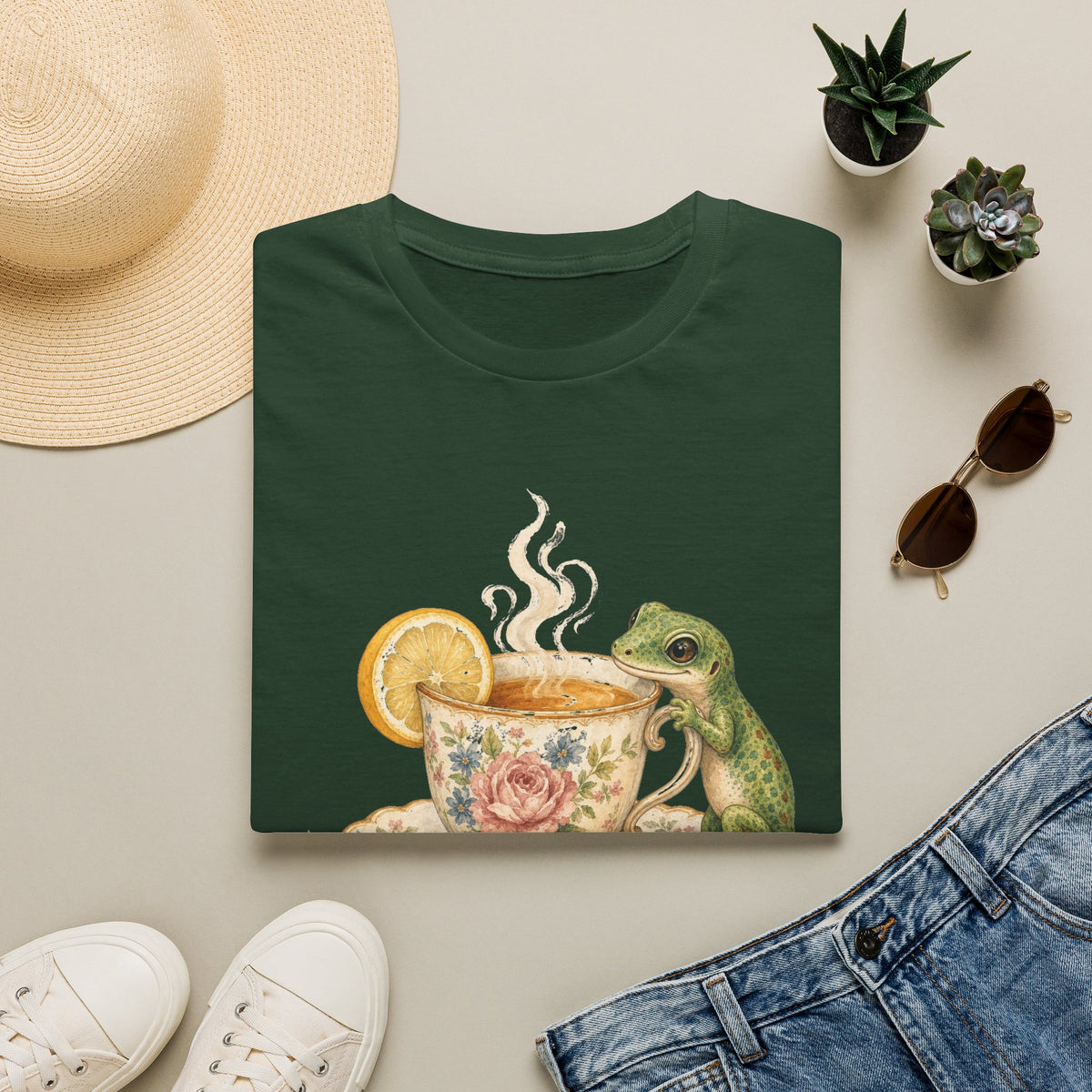 Tea Time Gecko cottagecore watercolor T-shirt from Gold Gecko Co. — gecko sipping from a floral teacup among daisies and lavender.