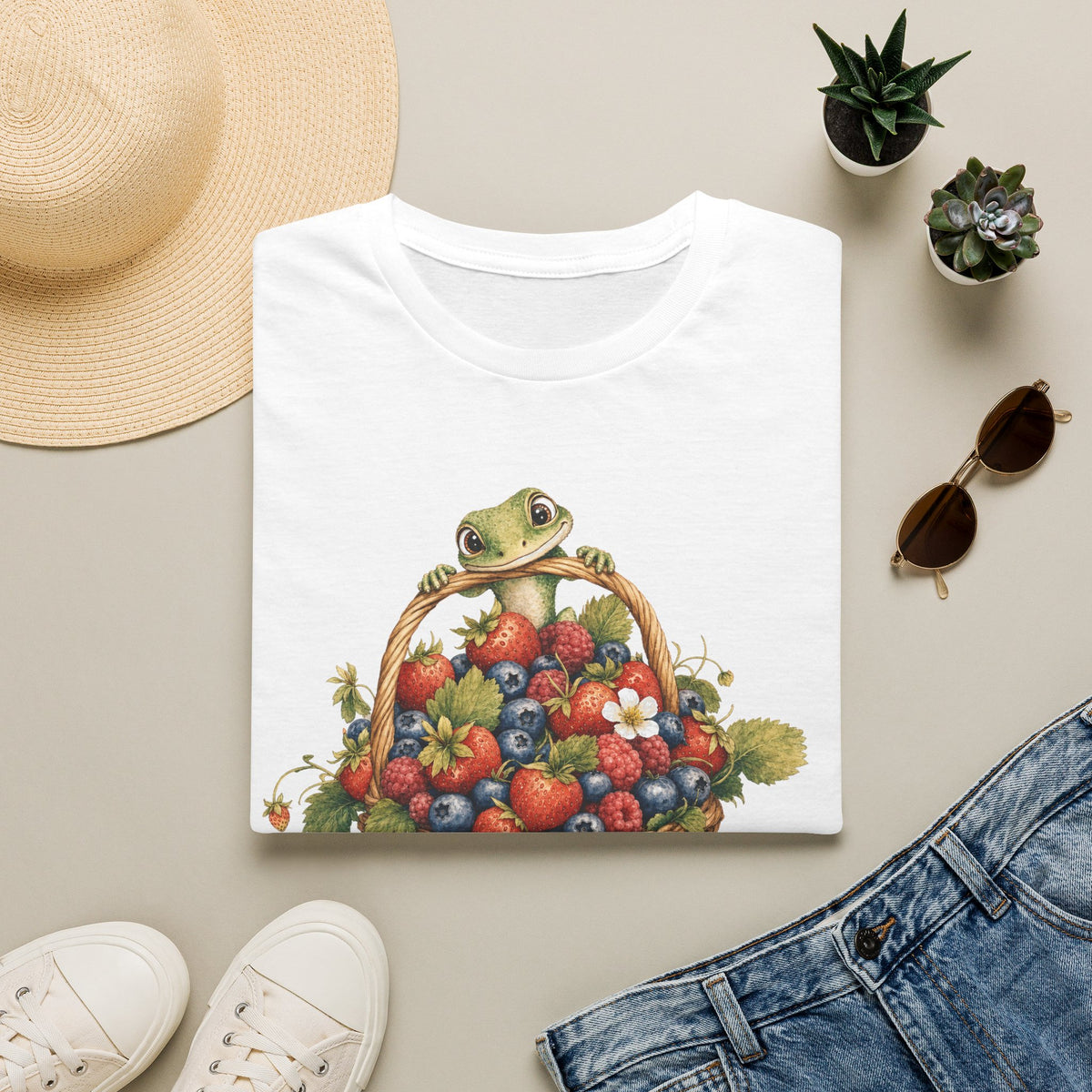 Berry Basket Buddy cottagecore watercolor T-shirt from Gold Gecko Co. — gecko nestled in a woven basket of wild strawberries and blueberries.