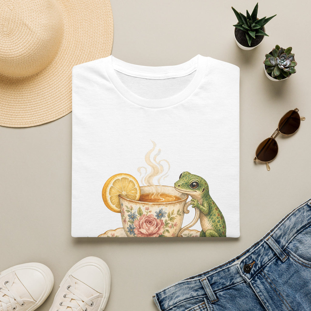 Tea Time Gecko cottagecore watercolor T-shirt from Gold Gecko Co. — gecko sipping from a floral teacup among daisies and lavender.