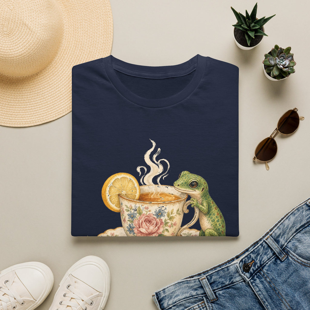 Tea Time Gecko cottagecore watercolor T-shirt from Gold Gecko Co. — gecko sipping from a floral teacup among daisies and lavender.