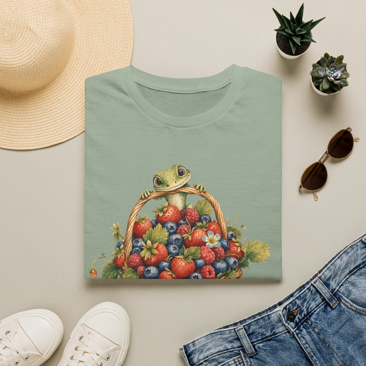 Berry Basket Buddy cottagecore watercolor T-shirt from Gold Gecko Co. — gecko nestled in a woven basket of wild strawberries and blueberries.