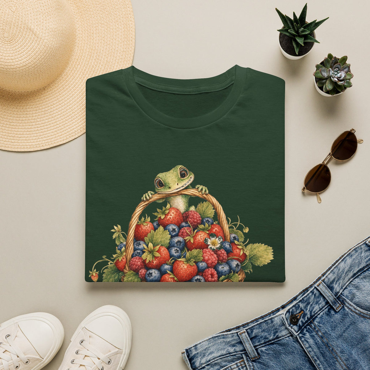 Berry Basket Buddy cottagecore watercolor T-shirt from Gold Gecko Co. — gecko nestled in a woven basket of wild strawberries and blueberries.