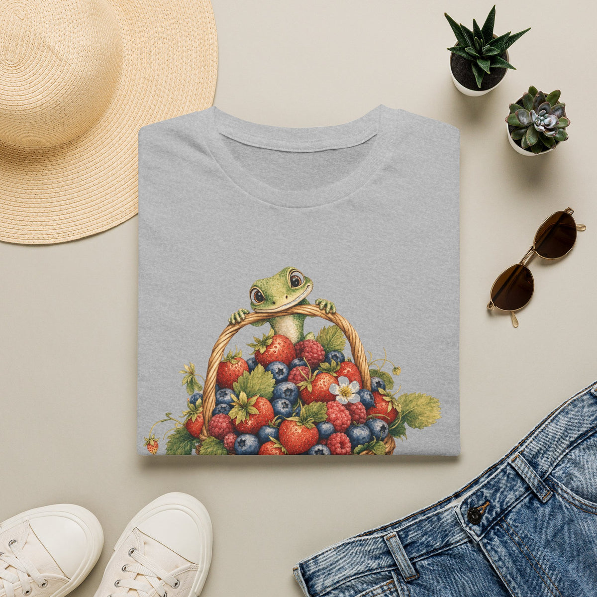 Berry Basket Buddy cottagecore watercolor T-shirt from Gold Gecko Co. — gecko nestled in a woven basket of wild strawberries and blueberries.