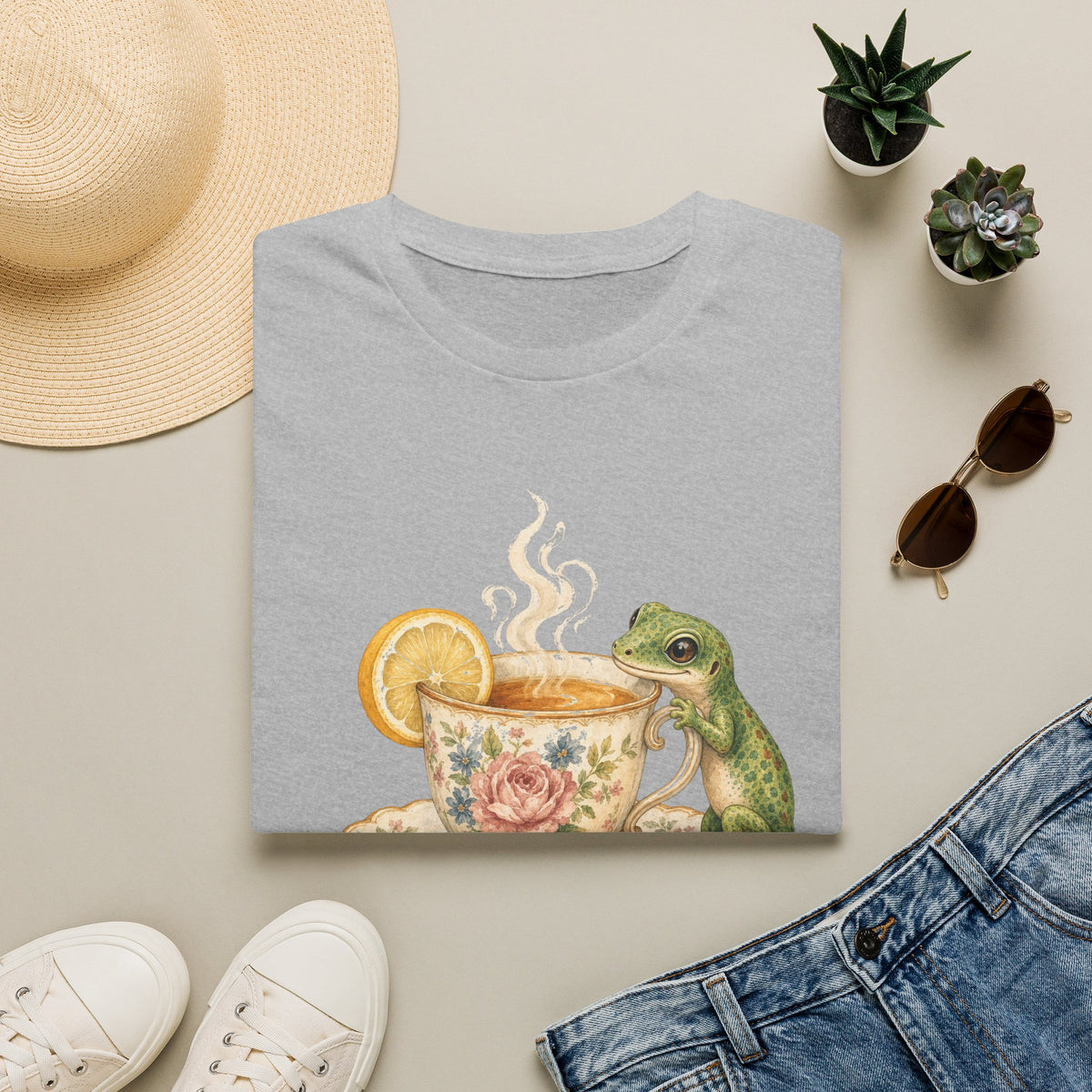 Tea Time Gecko cottagecore watercolor T-shirt from Gold Gecko Co. — gecko sipping from a floral teacup among daisies and lavender.