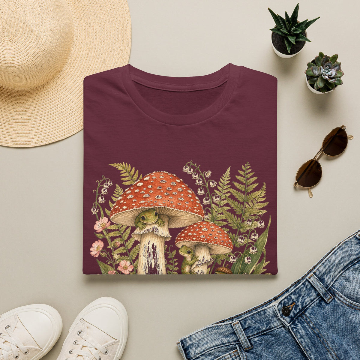 Mushroom Village cottagecore watercolor T-shirt from Gold Gecko Co. — gecko exploring a whimsical toadstool village in the woods.