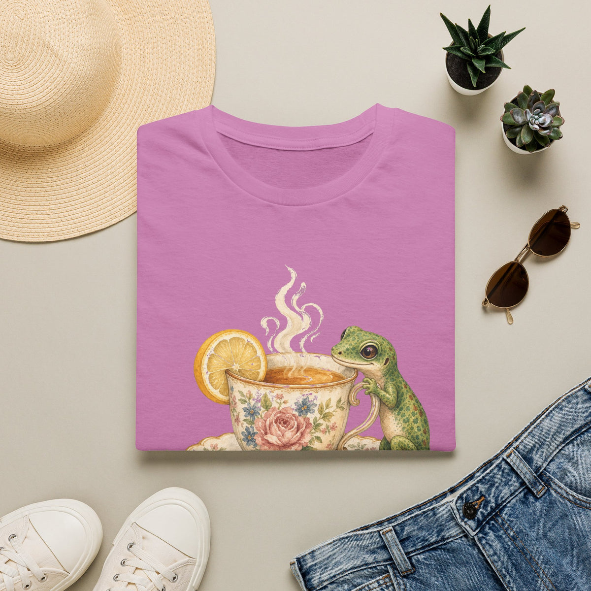 Tea Time Gecko cottagecore watercolor T-shirt from Gold Gecko Co. — gecko sipping from a floral teacup among daisies and lavender.