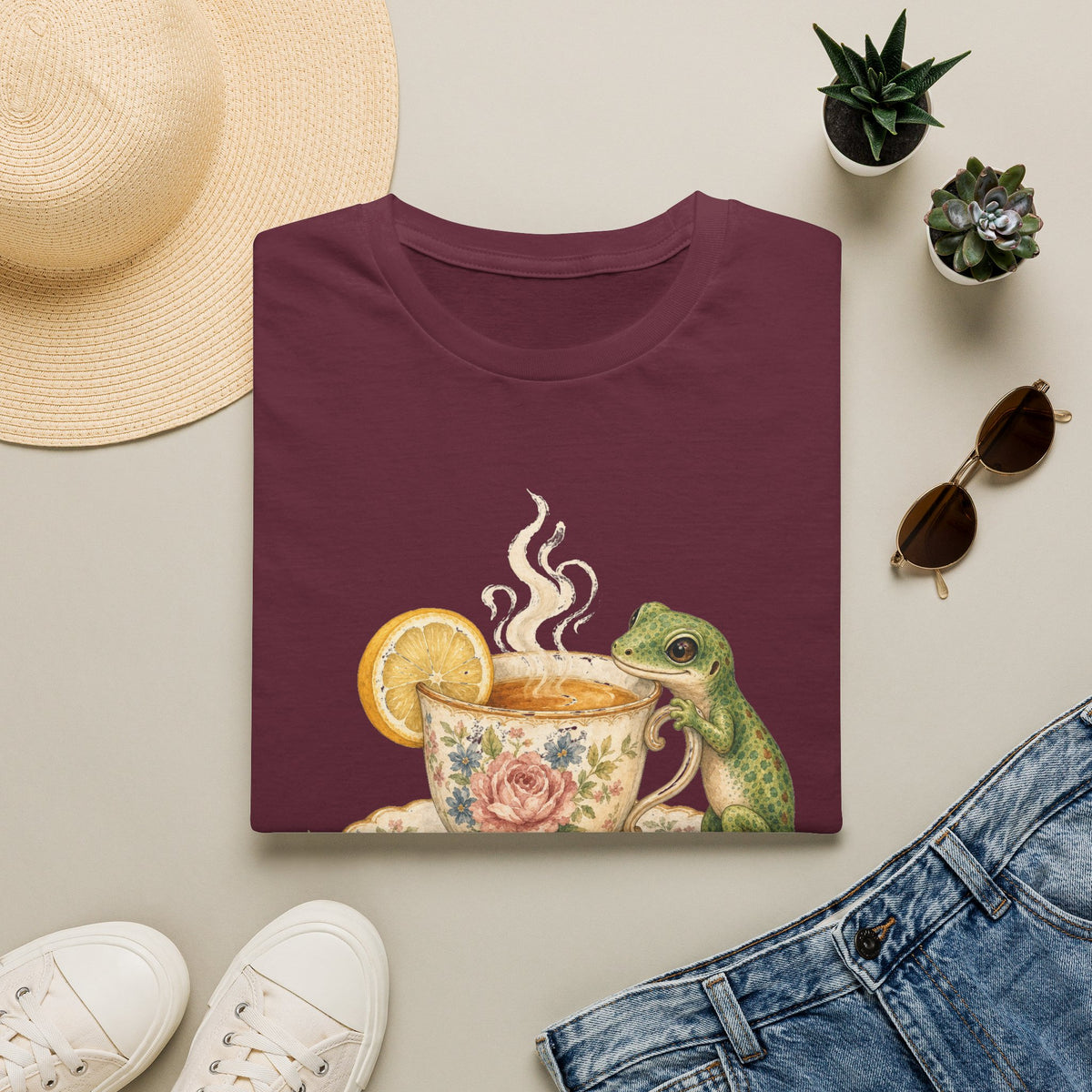 Tea Time Gecko cottagecore watercolor T-shirt from Gold Gecko Co. — gecko sipping from a floral teacup among daisies and lavender.