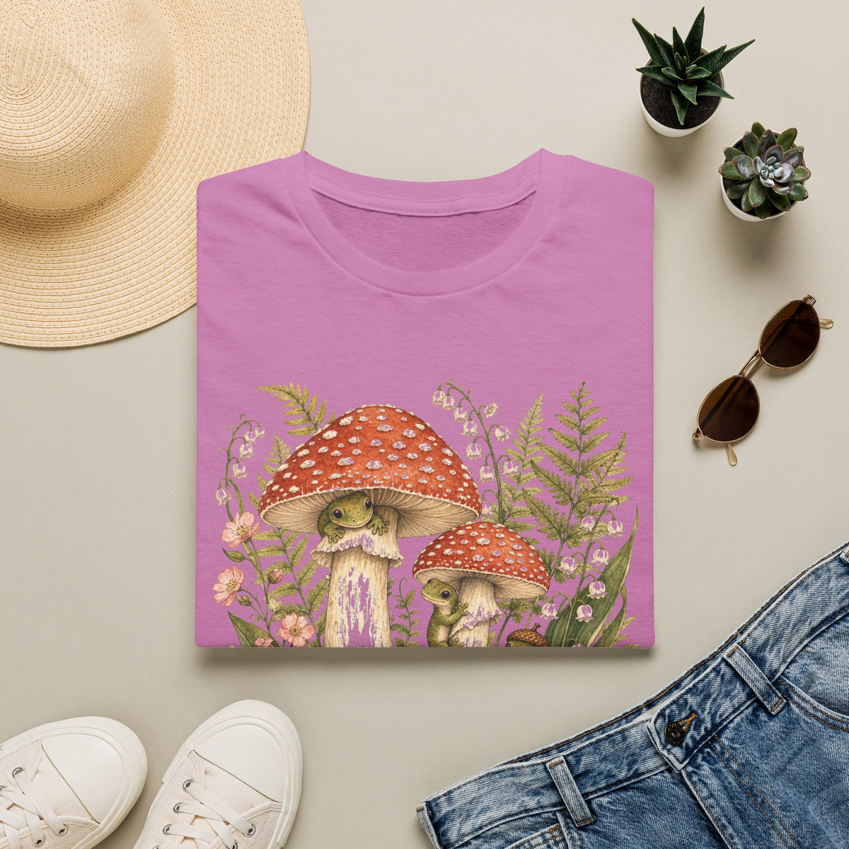 Mushroom Village cottagecore watercolor T-shirt from Gold Gecko Co. — gecko exploring a whimsical toadstool village in the woods.