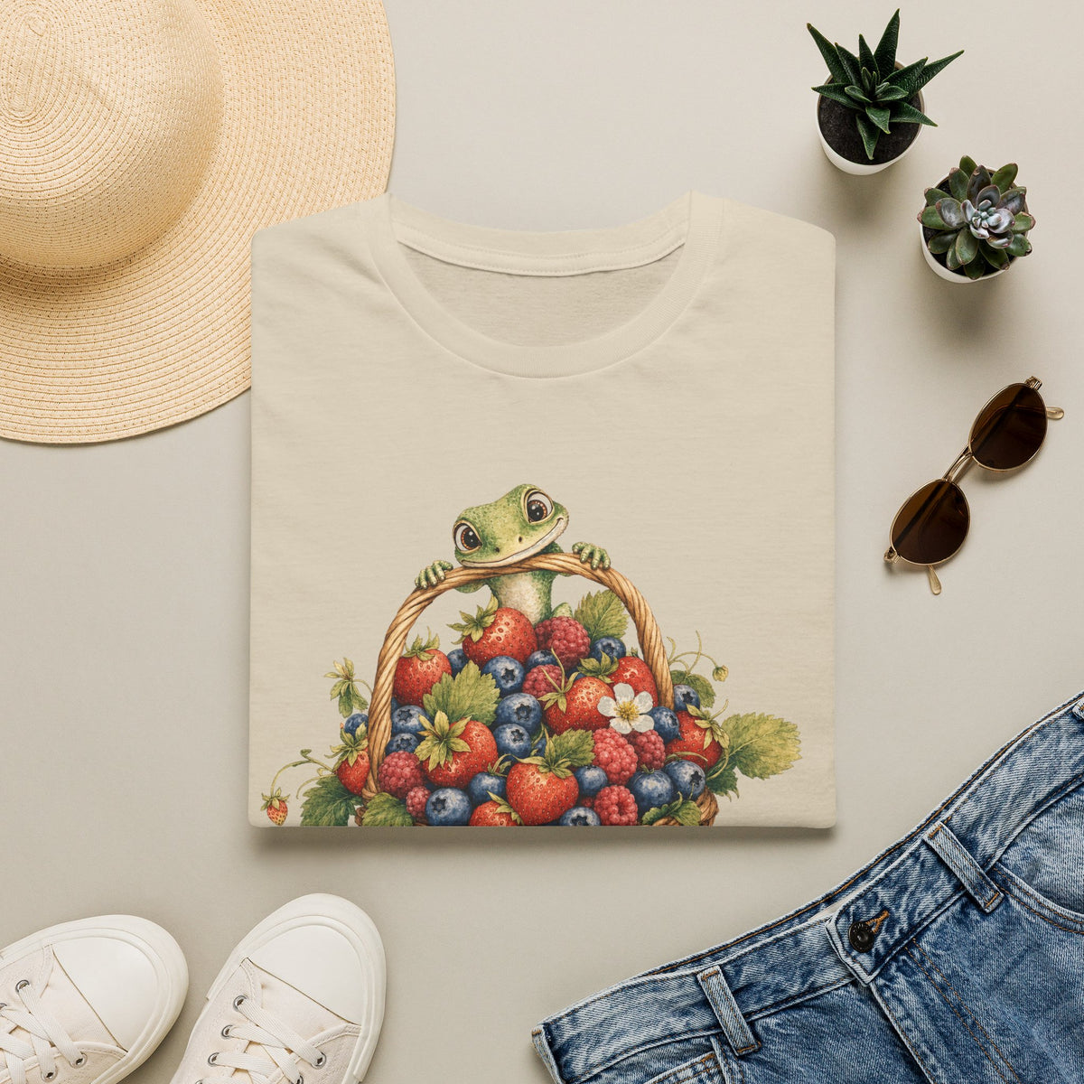 Berry Basket Buddy cottagecore watercolor T-shirt from Gold Gecko Co. — gecko nestled in a woven basket of wild strawberries and blueberries.