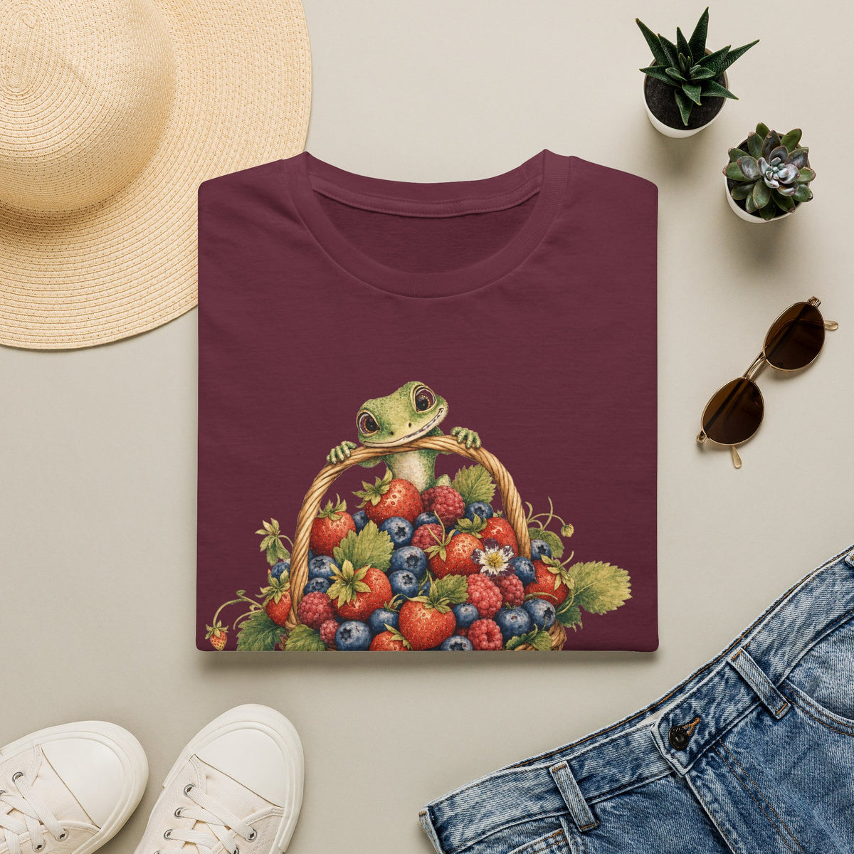 Berry Basket Buddy cottagecore watercolor T-shirt from Gold Gecko Co. — gecko nestled in a woven basket of wild strawberries and blueberries.