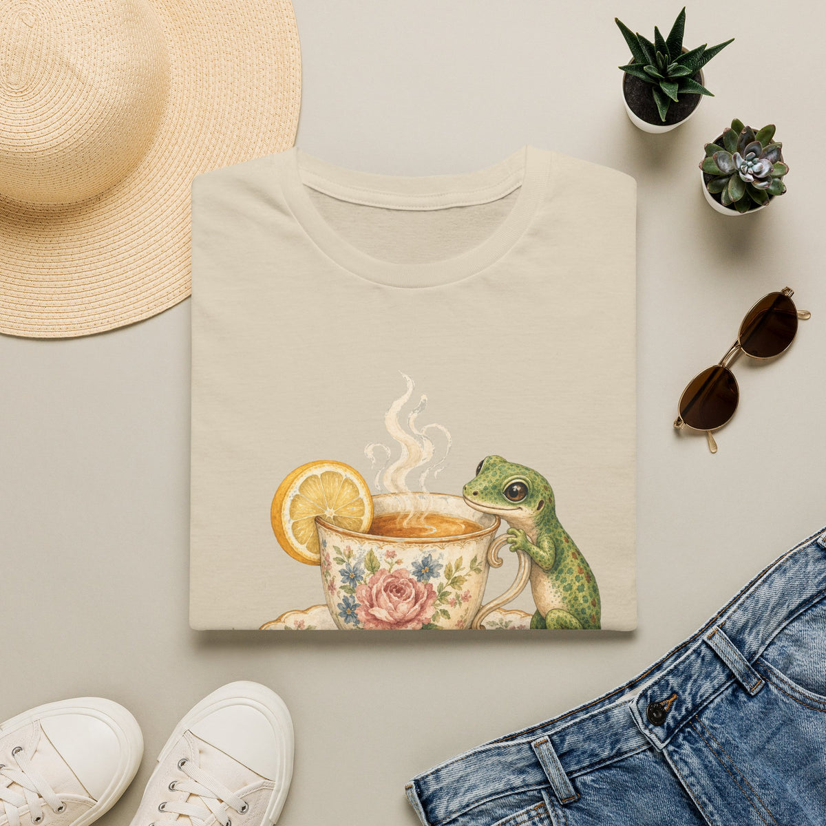 Tea Time Gecko cottagecore watercolor T-shirt from Gold Gecko Co. — gecko sipping from a floral teacup among daisies and lavender.